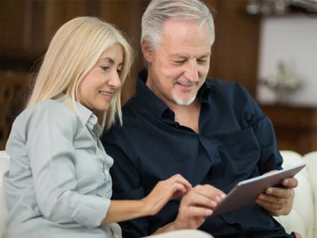 Couple reviewing content on tablet