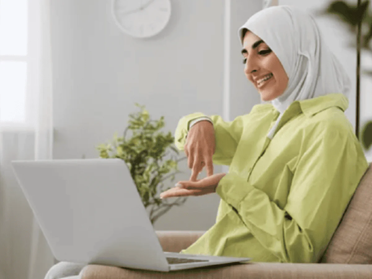 Woman smiling while using laptop