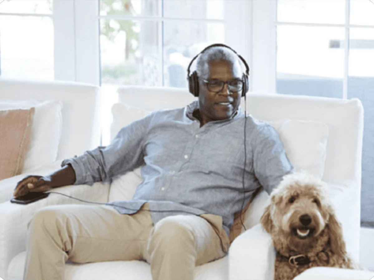 Man relaxing with dog and headphones